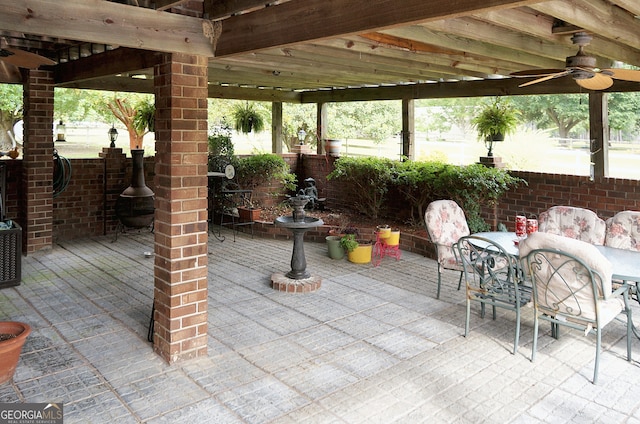 view of patio with outdoor dining area and ceiling fan