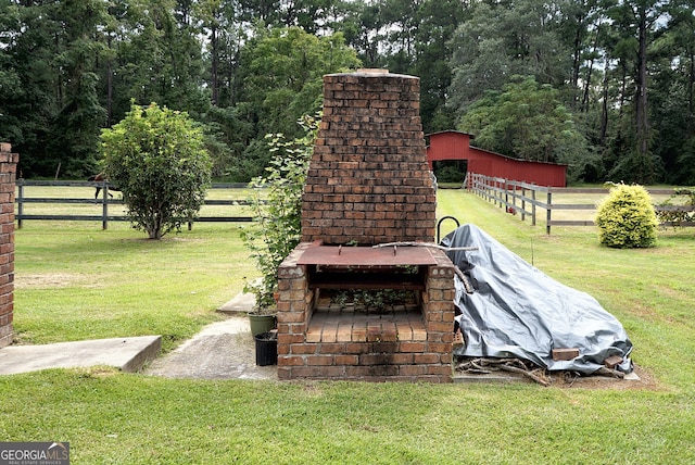 exterior details featuring fence and an outdoor brick fireplace