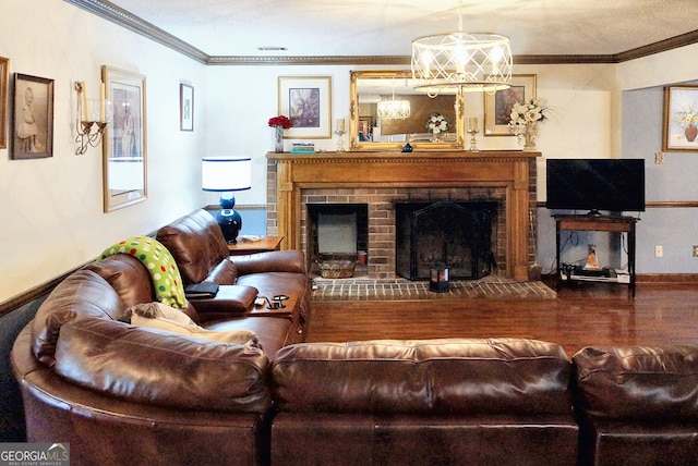 living room with wood finished floors, baseboards, visible vents, crown molding, and a brick fireplace