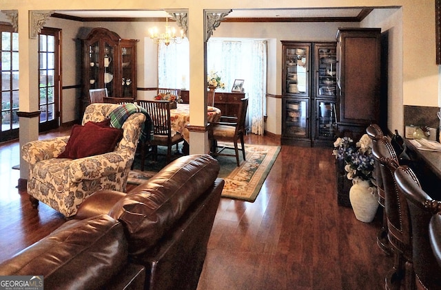 living room featuring a chandelier, wood finished floors, and crown molding