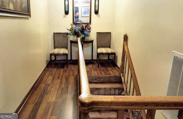 staircase featuring baseboards and wood finished floors