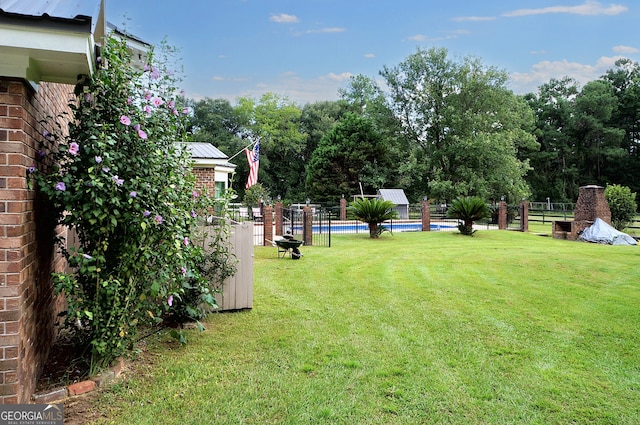 view of yard with a fenced in pool and fence