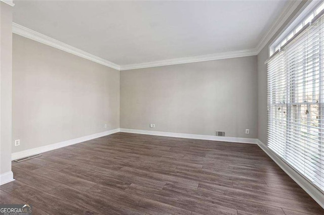 spare room with dark hardwood / wood-style floors and crown molding