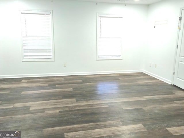 spare room with dark wood-type flooring