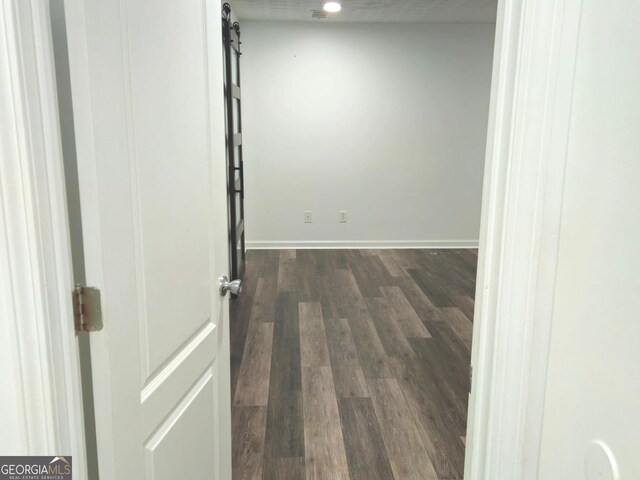 unfurnished living room featuring ceiling fan and dark hardwood / wood-style flooring