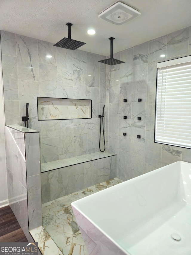 bathroom featuring separate shower and tub