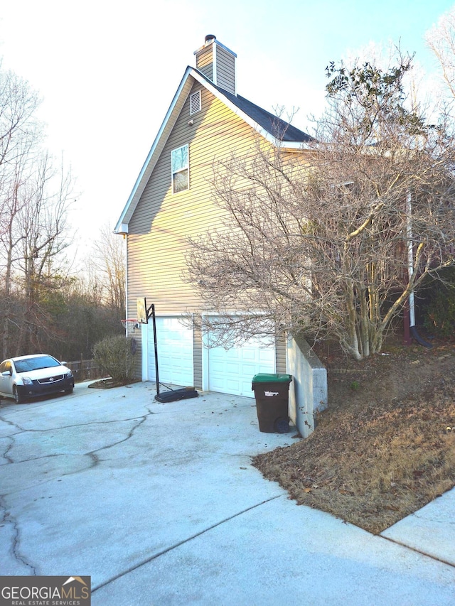 view of side of property with a garage