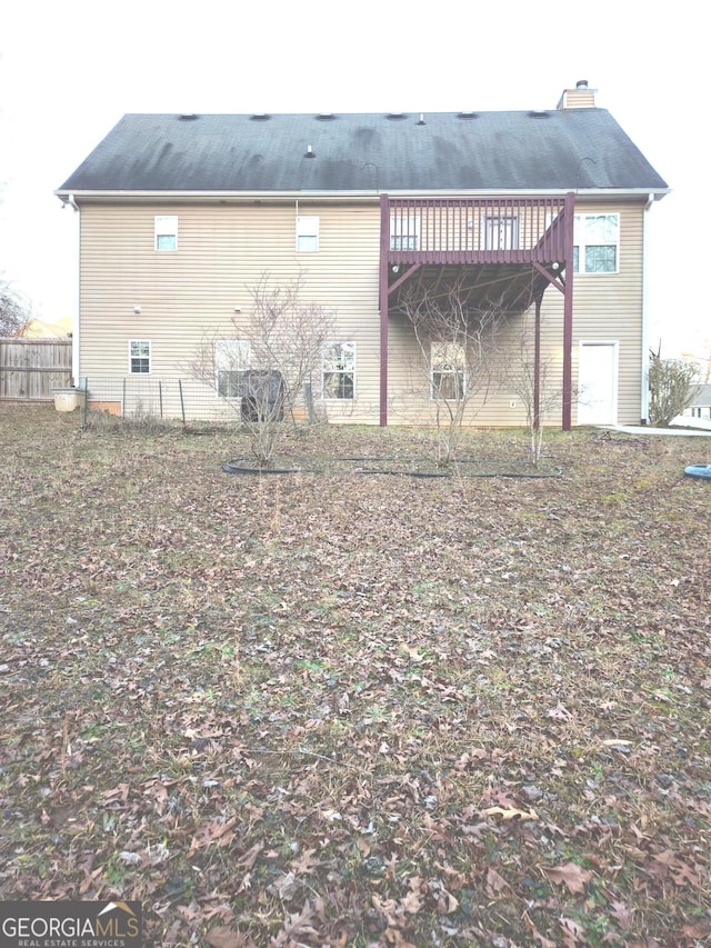 back of house with a deck