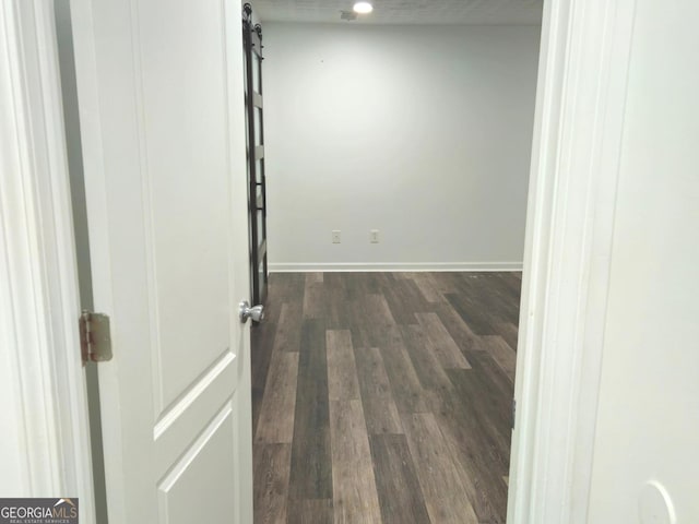 unfurnished room featuring dark wood-type flooring