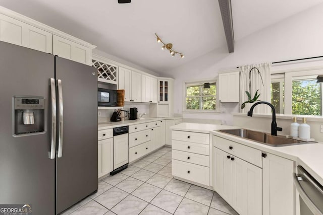 kitchen with lofted ceiling with beams, sink, white cabinetry, and stainless steel appliances