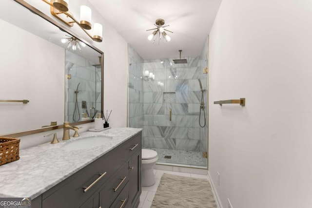 bathroom featuring an inviting chandelier, tile patterned flooring, toilet, a shower with door, and vanity