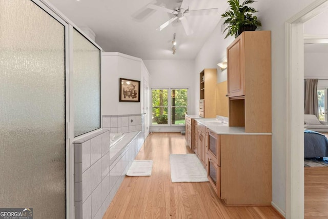 bathroom featuring hardwood / wood-style floors, vanity, shower with separate bathtub, and ceiling fan