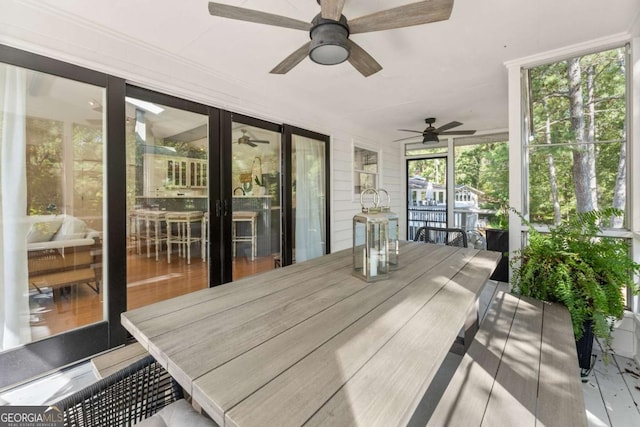 sunroom featuring ceiling fan