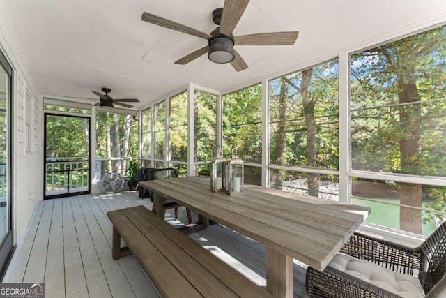 unfurnished sunroom with ceiling fan and a healthy amount of sunlight