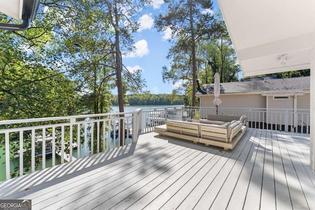 wooden terrace featuring a water view