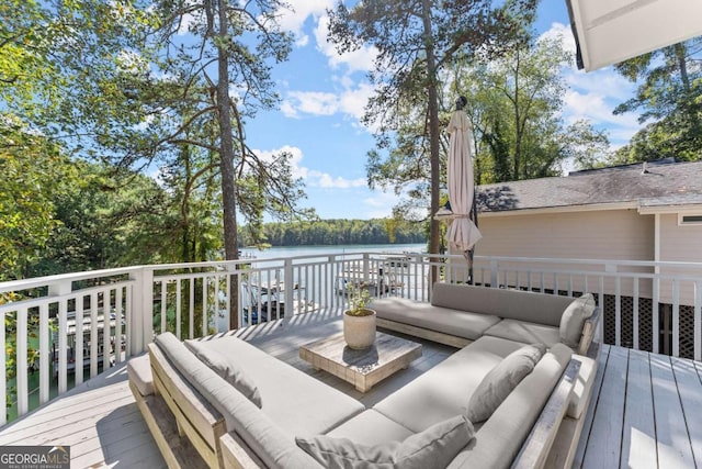 deck with outdoor lounge area and a water view