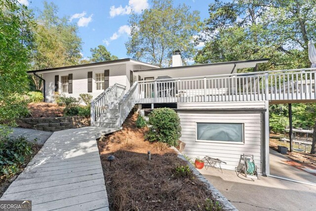 back of property with a wooden deck