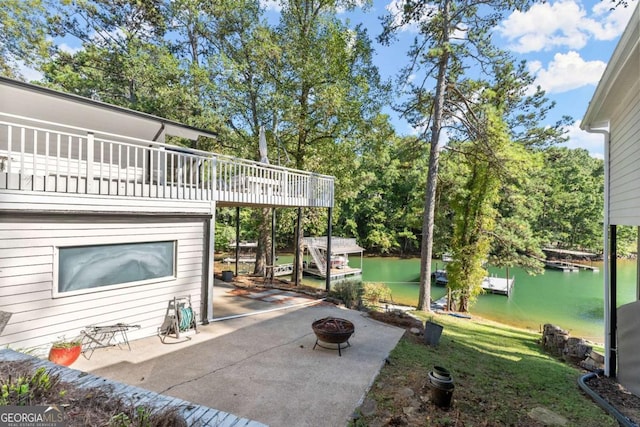 view of patio featuring a water view and a fire pit