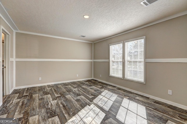 empty room with a textured ceiling and dark hardwood / wood-style floors