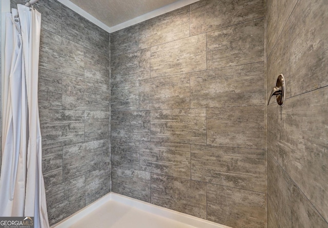 bathroom with a textured ceiling and walk in shower