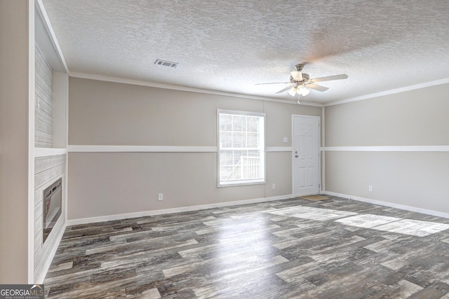 unfurnished living room featuring ceiling fan, ornamental molding, dark hardwood / wood-style floors, and a textured ceiling