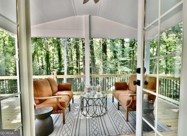 sunroom / solarium featuring lofted ceiling and ceiling fan