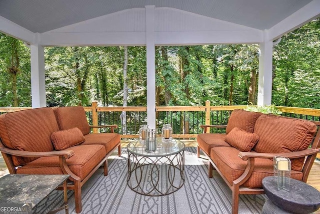 sunroom / solarium featuring vaulted ceiling