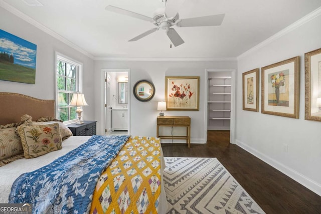 bedroom with ceiling fan, a walk in closet, ornamental molding, and connected bathroom