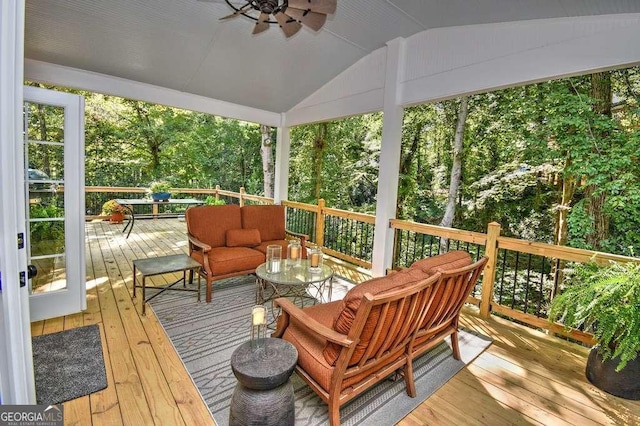 sunroom featuring a healthy amount of sunlight, ceiling fan, and vaulted ceiling