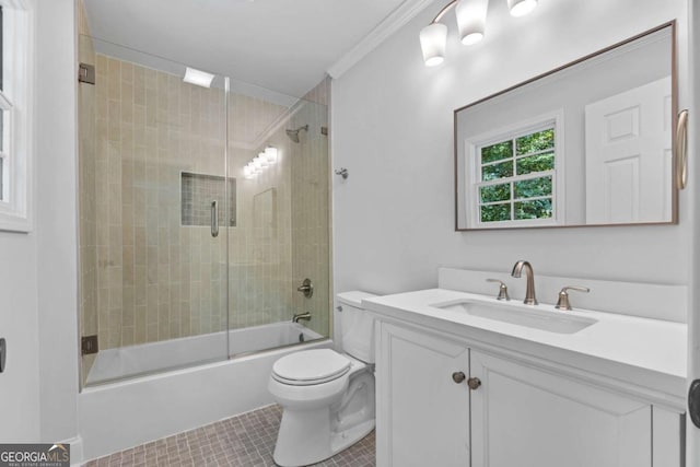 full bathroom featuring vanity, tile patterned floors, crown molding, toilet, and enclosed tub / shower combo