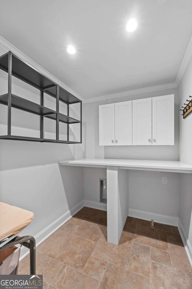 laundry room with cabinets and crown molding