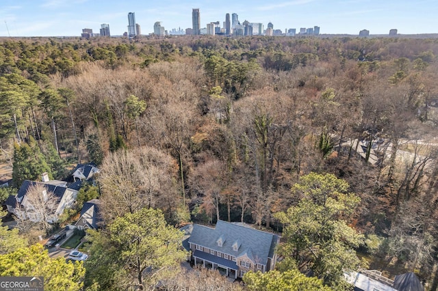 aerial view with a city view and a wooded view