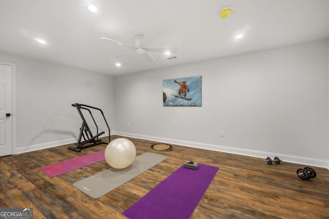 exercise area featuring recessed lighting, baseboards, and wood finished floors