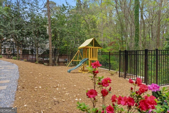 view of jungle gym featuring fence