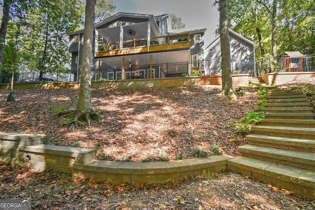 rear view of property with stairway