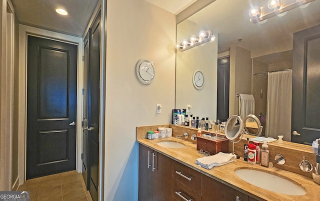 bathroom with a shower with shower curtain, vanity, and tile patterned floors