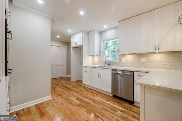 kitchen featuring white cabinets, sink, stainless steel dishwasher, light hardwood / wood-style floors, and light stone counters