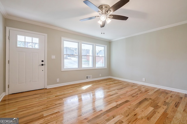 entryway with light hardwood / wood-style flooring, plenty of natural light, ornamental molding, and ceiling fan