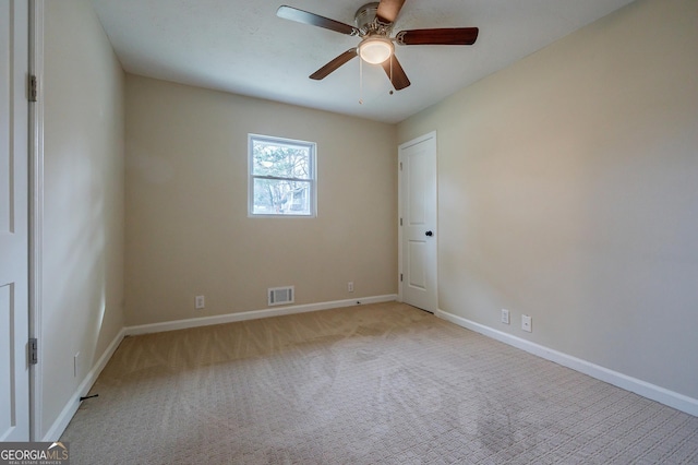 carpeted empty room featuring ceiling fan