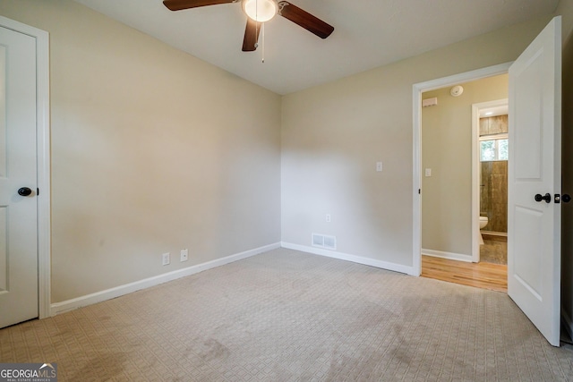 unfurnished bedroom with light carpet and ceiling fan