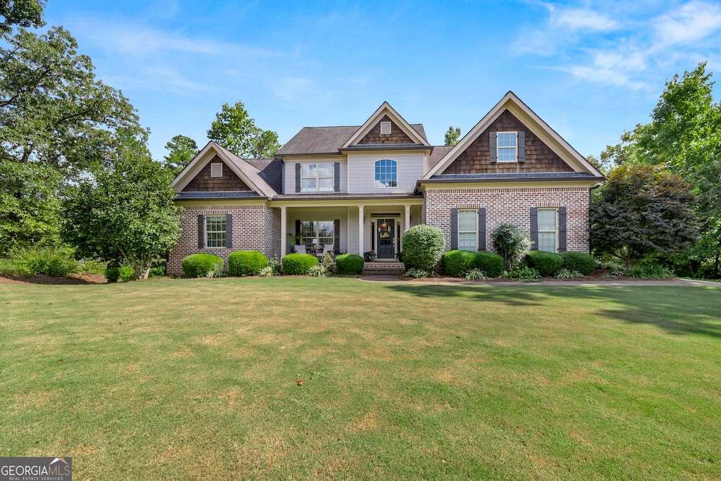 craftsman-style house with a front yard and a porch