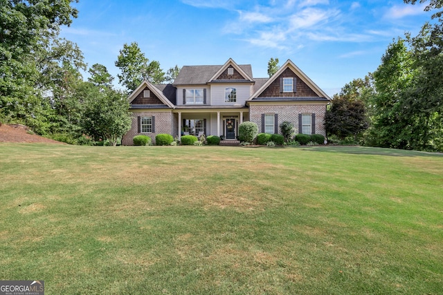 craftsman inspired home featuring covered porch and a front lawn