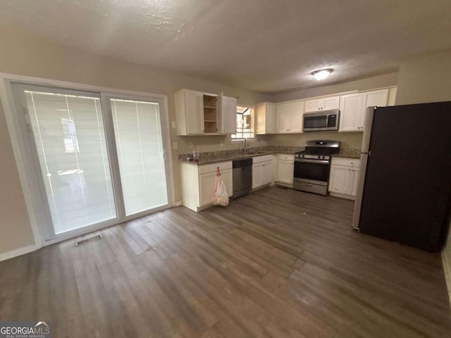 kitchen featuring white cabinets, stainless steel appliances, dark hardwood / wood-style floors, and sink