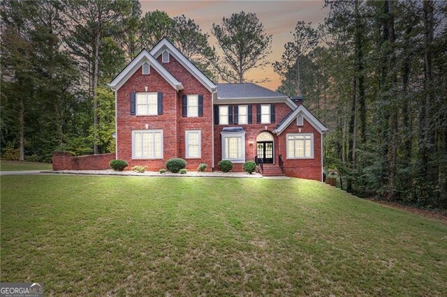 view of front of home featuring a yard and french doors