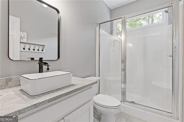 full bathroom with tile patterned flooring, toilet, a shower stall, and vanity