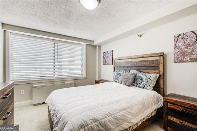 carpeted bedroom featuring a textured ceiling and radiator