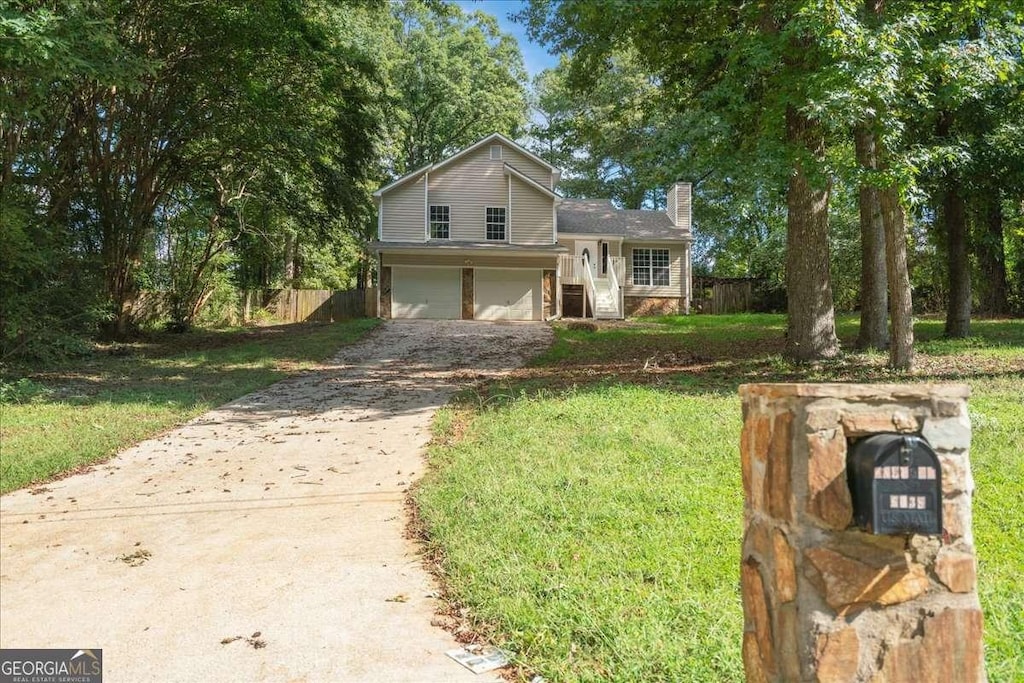 view of front of house featuring a garage and a front lawn