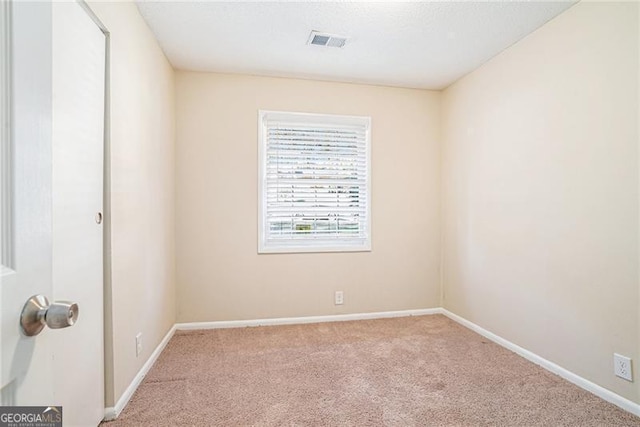 spare room with light carpet