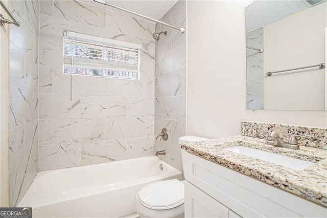 full bathroom featuring tiled shower / bath combo, toilet, a textured ceiling, and vanity