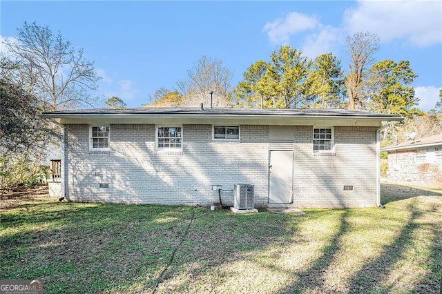 rear view of property with a yard and central AC